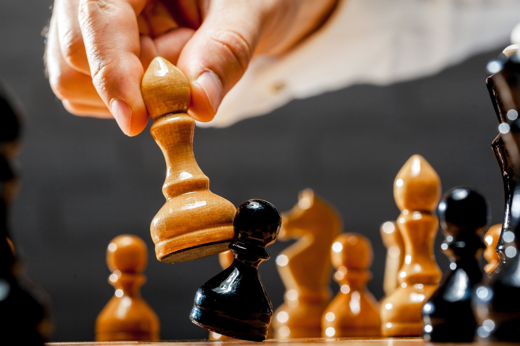 Hand of businessman playing chess